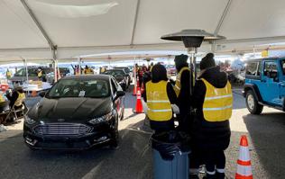 Car entering tent at mass vaccination event in March 2021