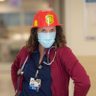 Nurse wearing fire chief hat