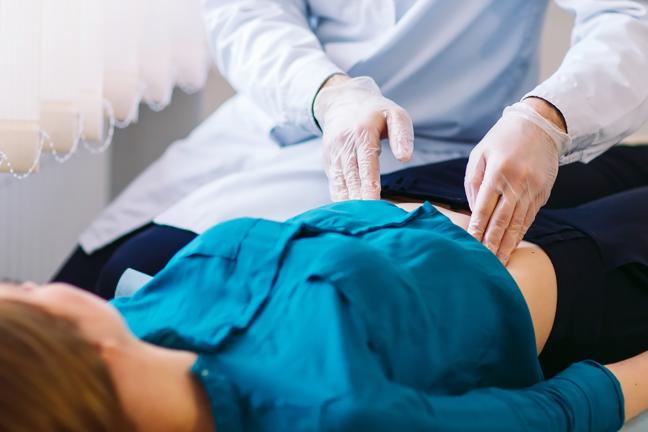 Photo of a gastroenterologist working with a patient