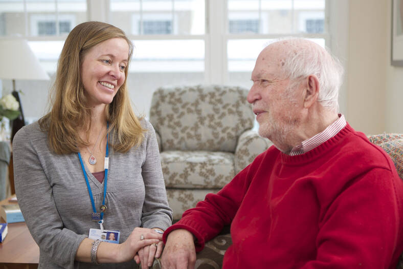 Geriatrics team member chatting with an APD patient